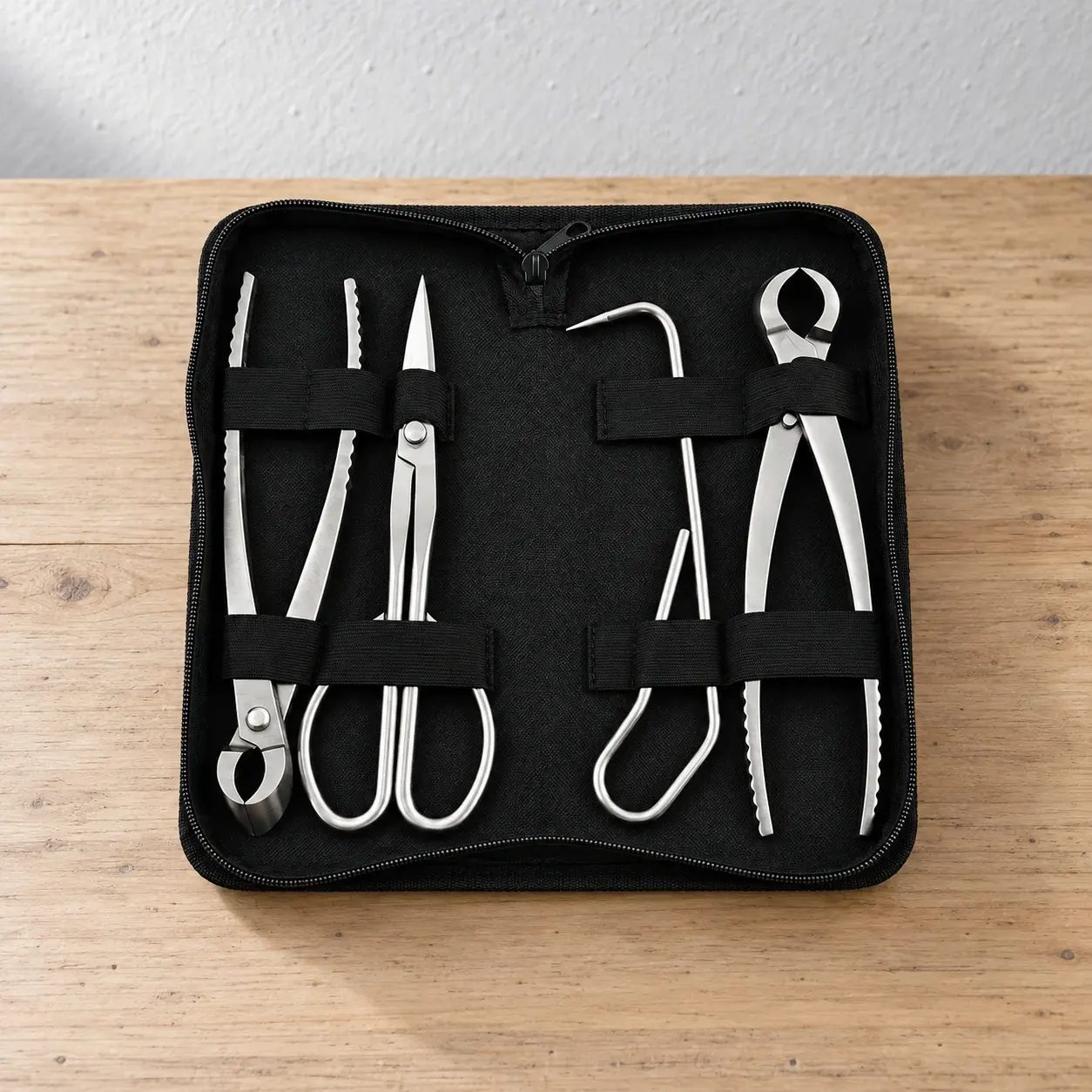 Four polished bonsai tools inside an open black case