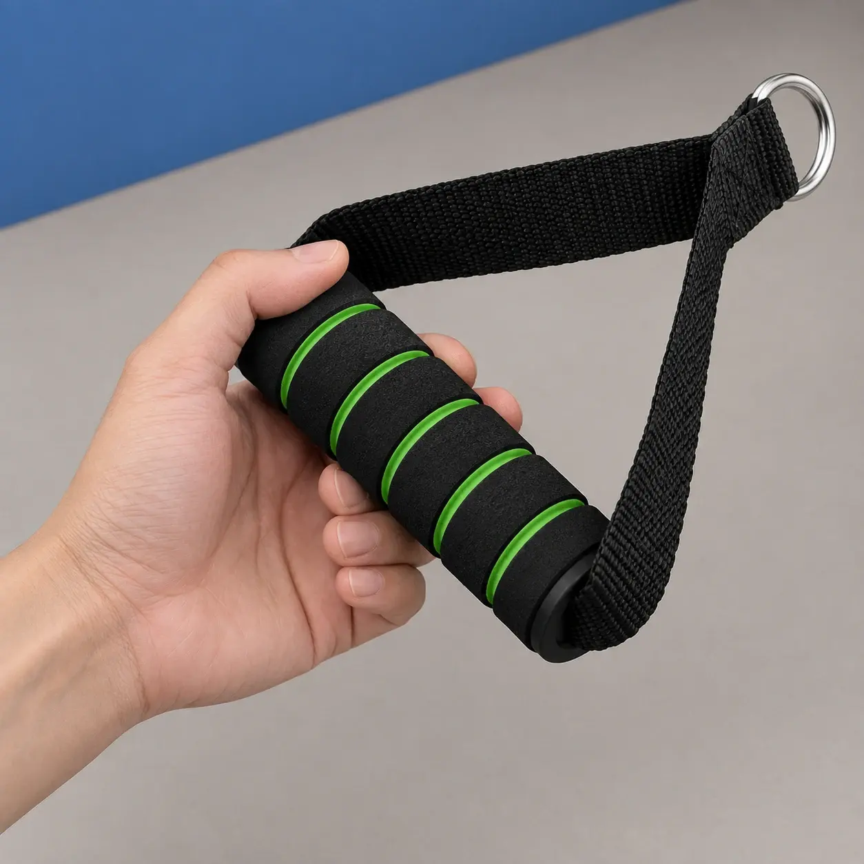 One black-and-green handle held by hand, a component view of the complete resistance kit. Reference-conditioned image.