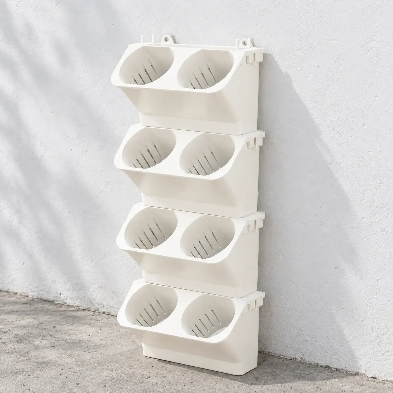 Four linked cream wall-planter modules with eight pockets