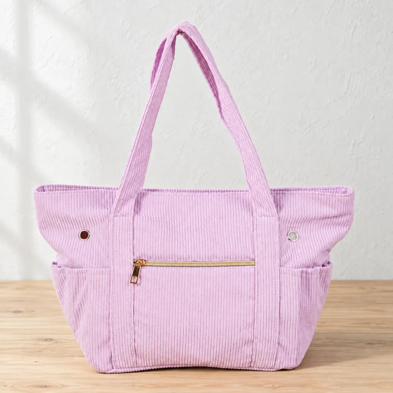 Lilac corduroy project bag on a natural wood table